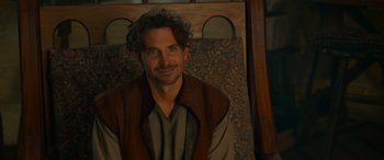 Movie still from “Dungeons & Dragons: Honor Among Thieves” (2023), directed by John Francis Daley – A person sitting in front of a wall; Medium shot, Over the shoulder angle