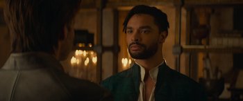 Movie still from “Dungeons & Dragons: Honor Among Thieves” (2023), directed by John Francis Daley – A man in a green jacket looking into a mirror; Close Up shot, Over the shoulder angle