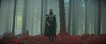 Movie still from “Dungeons & Dragons: Honor Among Thieves” (2023), directed by John Francis Daley – A man dressed in armor and holding a sword in the woods; Wide shot, Low angle