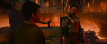 Movie still from “Dungeons & Dragons: Honor Among Thieves” (2023), directed by John Francis Daley – A man in a suit of armor talking to another man; Medium shot, Over the shoulder angle