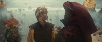 Movie still from “Dungeons & Dragons: Honor Among Thieves” (2023), directed by John Francis Daley – Two men in medieval garb talking in front of the ocean; Medium shot, Over the shoulder angle