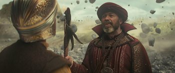 Movie still from “Dungeons & Dragons: Honor Among Thieves” (2023), directed by John Francis Daley – An old man holding a spear in a field; Medium shot, Over the shoulder angle