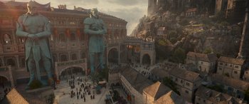 Movie still from “Dungeons & Dragons: Honor Among Thieves” (2023), directed by John Francis Daley – An aerial view of a city with a large statue of a man in the middle of it; Extreme Wide shot, High angle