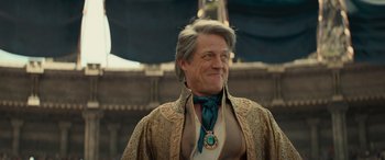 Movie still from “Dungeons & Dragons: Honor Among Thieves” (2023), directed by John Francis Daley – A person wearing a suit and tie; Close Up shot, Over the shoulder angle