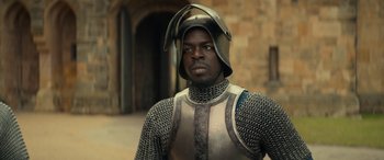 Movie still from “Dungeons & Dragons: Honor Among Thieves” (2023), directed by John Francis Daley – A man in a suit of armor and a helmet; Close Up shot, Over the shoulder angle