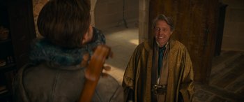 Movie still from “Dungeons & Dragons: Honor Among Thieves” (2023), directed by John Francis Daley – A man dressed as a wizard is smiling at a young boy; Medium shot, Over the shoulder angle