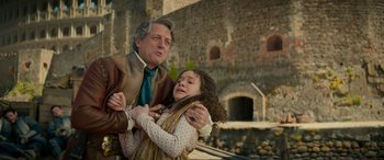 Movie still from “Dungeons & Dragons: Honor Among Thieves” (2023), directed by John Francis Daley – A man and a young girl are hugging outside; Medium shot, Low angle