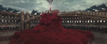 Movie still from “Dungeons & Dragons: Honor Among Thieves” (2023), directed by John Francis Daley – A red cloud of smoke coming out of a building; Extreme Wide shot, High angle