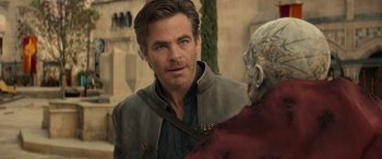 Movie still from “Dungeons & Dragons: Honor Among Thieves” (2023), directed by John Francis Daley – A man in a leather jacket talking to another man; Close Up shot, Over the shoulder angle