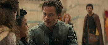 Movie still from “Dungeons & Dragons: Honor Among Thieves” (2023), directed by John Francis Daley – A person wearing a leather jacket; Close Up shot, Over the shoulder angle