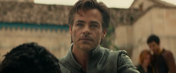 Movie still from “Dungeons & Dragons: Honor Among Thieves” (2023), directed by John Francis Daley – A person wearing a leather jacket; Close Up shot, Over the shoulder angle