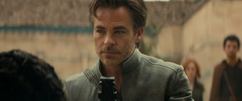 Movie still from “Dungeons & Dragons: Honor Among Thieves” (2023), directed by John Francis Daley – A person wearing a suit and tie; Close Up shot, Over the shoulder angle