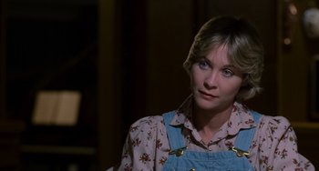 Movie still from “E.T. the Extra-Terrestrial” (1982), directed by Steven Spielberg – A woman with short blonde hair wearing a floral shirt; Close Up shot, Over the shoulder angle