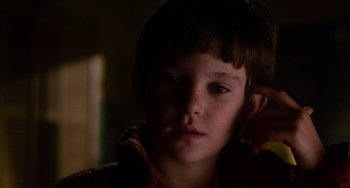 Movie still from “E.T. the Extra-Terrestrial” (1982), directed by Steven Spielberg – A young boy is looking into the camera; Close Up shot, Low angle