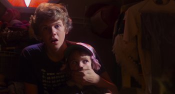 Movie still from “E.T. the Extra-Terrestrial” (1982), directed by Steven Spielberg – Two young people are posing for a picture; Close Up shot, Over the shoulder angle