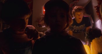 Movie still from “E.T. the Extra-Terrestrial” (1982), directed by Steven Spielberg – A girl is getting her hair brushed by a woman; Close Up shot, Over the shoulder angle