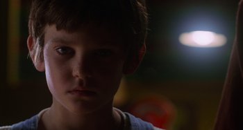 Movie still from “E.T. the Extra-Terrestrial” (1982), directed by Steven Spielberg – A young boy is staring into the camera; Close Up shot, Low angle
