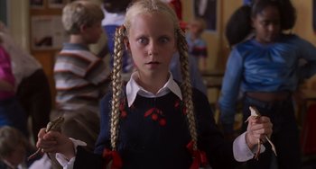 Movie still from “E.T. the Extra-Terrestrial” (1982), directed by Steven Spielberg – A young girl with blonde plaited pigtails; Close Up shot, High angle