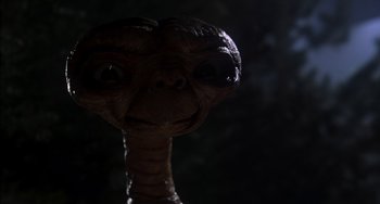 Movie still from “E.T. the Extra-Terrestrial” (1982), directed by Steven Spielberg – An extraterrestrials face in the dark; Close Up shot, Low angle