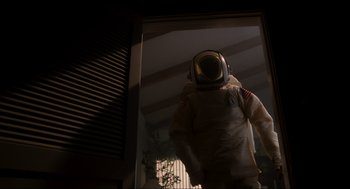 Movie still from “E.T. the Extra-Terrestrial” (1982), directed by Steven Spielberg – A person in a spacesuit standing in front of a window; Wide shot, Low angle