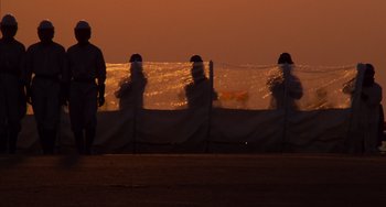 Movie still from “E.T. the Extra-Terrestrial” (1982), directed by Steven Spielberg – A group of people standing on top of a beach; Extreme Wide shot, Low angle