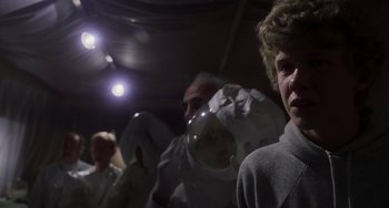 Movie still from “E.T. the Extra-Terrestrial” (1982), directed by Steven Spielberg – A group of people standing next to each other in a room; Medium shot, Low angle