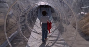 Movie still from “E.T. the Extra-Terrestrial” (1982), directed by Steven Spielberg – A woman walking through a tunnel made out of plastic bags; Wide shot, Low angle