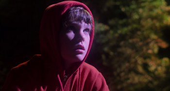 Movie still from “E.T. the Extra-Terrestrial” (1982), directed by Steven Spielberg – A young boy wearing a red hooded sweatshirt; Close Up shot, Low angle