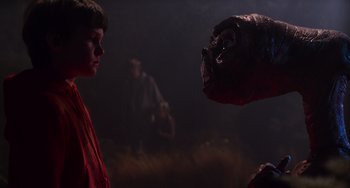Movie still from “E.T. the Extra-Terrestrial” (1982), directed by Steven Spielberg – A boy in a red robe looking at a gorilla; Close Up shot, Over the shoulder angle