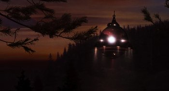 Movie still from “E.T. the Extra-Terrestrial” (1982), directed by Steven Spielberg – A dark sky with a dome shaped building in the middle of the night; Extreme Wide shot, Low angle