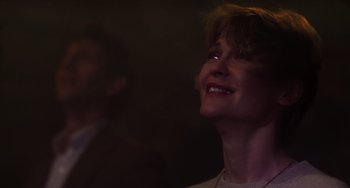 Movie still from “E.T. the Extra-Terrestrial” (1982), directed by Steven Spielberg – A woman smiling with her mouth open in the dark; Close Up shot, Low angle