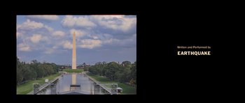 Movie still from “Chappelle's Home Team - Earthquake: Legendary” (2022), directed by Stan Lathan – A view of the washington monument from across the river; Extreme Wide shot, High angle