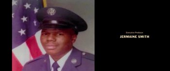 Movie still from “Chappelle's Home Team - Earthquake: Legendary” (2022), directed by Stan Lathan – A man in a military uniform is in front of a black background; Extreme Close Up shot, Low angle