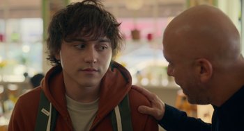 Movie still from “Easter Sunday” (2022), directed by Jay Chandrasekhar – A young man is being comforted by an older man; Close Up shot, Over the shoulder angle