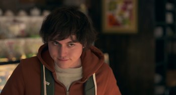 Movie still from “Easter Sunday” (2022), directed by Jay Chandrasekhar – A young man in a brown jacket is looking at the camera; Close Up shot, Over the shoulder angle