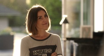 Movie still from “Easter Sunday” (2022), directed by Jay Chandrasekhar – A beautiful woman with short brown hair standing outside; Close Up shot, Low angle