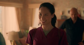 Movie still from “Easter Sunday” (2022), directed by Jay Chandrasekhar – A woman in a red shirt smiling for the camera; Close Up shot, Over the shoulder angle
