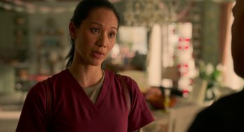 Movie still from “Easter Sunday” (2022), directed by Jay Chandrasekhar – A woman in a red shirt is standing in a room; Close Up shot, Over the shoulder angle