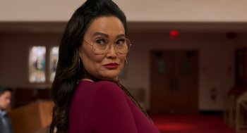 Movie still from “Easter Sunday” (2022), directed by Jay Chandrasekhar – A person wearing glasses and a red shirt; Close Up shot, Over the shoulder angle