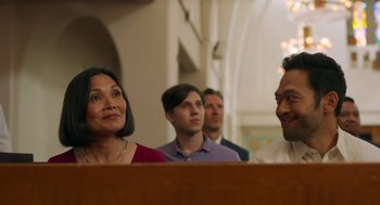 Movie still from “Easter Sunday” (2022), directed by Jay Chandrasekhar – A group of people standing in front of a wooden table; Close Up shot, Low angle