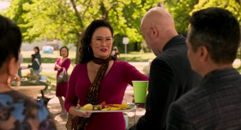 Movie still from “Easter Sunday” (2022), directed by Jay Chandrasekhar – A woman holding a tray of food in front of a man; Medium shot, Over the shoulder angle
