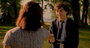 Movie still from “Easter Sunday” (2022), directed by Jay Chandrasekhar – A man in a suit and tie shaking hands with a woman in a dress; Medium shot, Over the shoulder angle