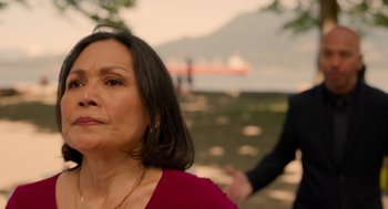 Movie still from “Easter Sunday” (2022), directed by Jay Chandrasekhar – An older woman in a red dress looking at a man in a black suit; Close Up shot, Over the shoulder angle