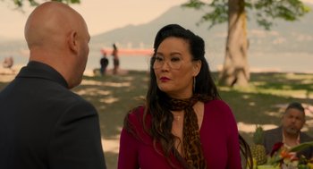 Movie still from “Easter Sunday” (2022), directed by Jay Chandrasekhar – A woman in a red shirt and a leopard print scarf; Medium shot, Over the shoulder angle