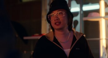 Movie still from “Easter Sunday” (2022), directed by Jay Chandrasekhar – A woman wearing glasses and wearing a hat; Close Up shot, Over the shoulder angle