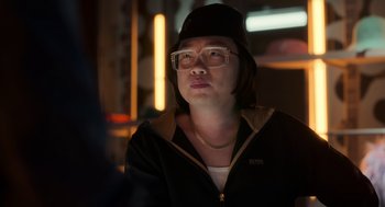 Movie still from “Easter Sunday” (2022), directed by Jay Chandrasekhar – A woman wearing glasses and a hat looking up; Close Up shot, Over the shoulder angle