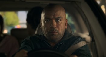 Movie still from “Easter Sunday” (2022), directed by Jay Chandrasekhar – A man sitting in the drivers seat of a car; Close Up shot, Low angle