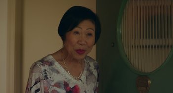 Movie still from “Easter Sunday” (2022), directed by Jay Chandrasekhar – An older asian woman wearing a floral shirt; Close Up shot, Over the shoulder angle