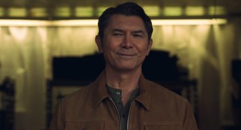 Movie still from “Easter Sunday” (2022), directed by Jay Chandrasekhar – A person wearing a brown jacket; Close Up shot, Low angle