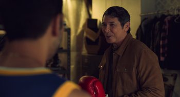 Movie still from “Easter Sunday” (2022), directed by Jay Chandrasekhar – A man in a brown jacket is talking to a man in a blue and yellow shirt; Medium shot, Over the shoulder angle